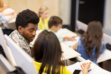 Image showing group of students talking in lecture hall