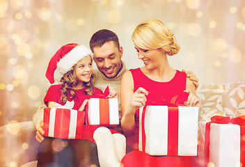 Image showing happy family opening gift boxes