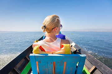 Image showing Female tourist travels by traditional boat.