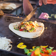Image showing Chef making chicken with grilled vegetable tortilla wrap on street stall.