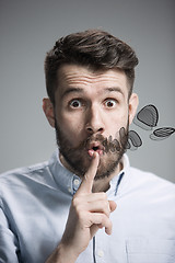 Image showing Man is looking wary. Over gray background