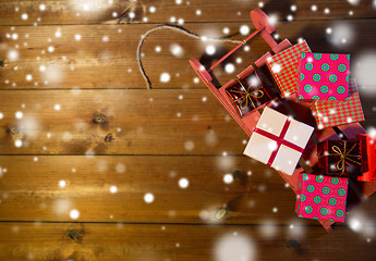 Image showing close up of christmas gift boxes on wooden sleigh