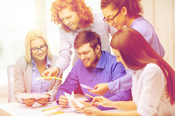 Image showing smiling team with color samples at office