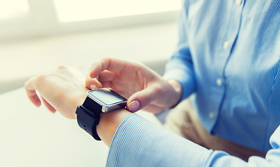 Image showing close up of hands setting smart watch