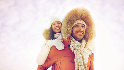 Image showing happy couple having fun over winter background