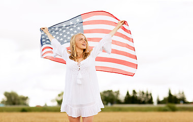 Image showing happy woman with american flag on cereal field