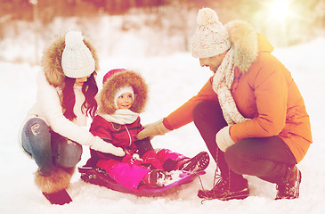 Image showing happy family with sled walking in winter forest