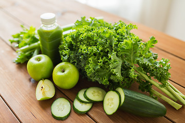 Image showing close up of bottle with green juice and vegetables