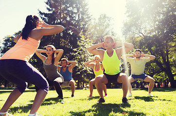 Image showing group of friends or sportsmen exercising outdoors