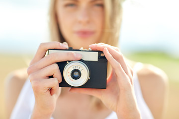 Image showing close up of woman photographing with film camera