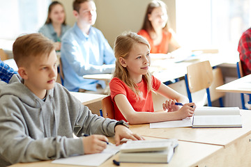 Image showing group of students with notebooks at school lesson