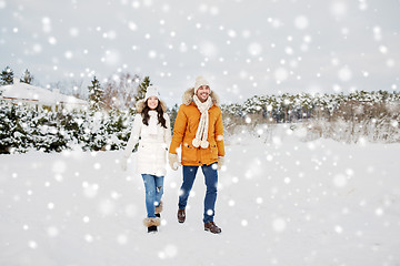 Image showing happy couple walking along snowy winter field