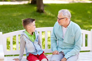 Image showing grandfather and grandson talking at summer park