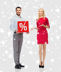 Image showing happy couple with red sale sign over snow