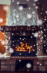 Image showing close up of burning fireplace with snow