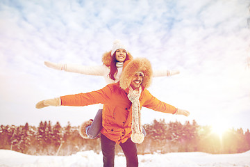 Image showing happy couple having fun over winter background