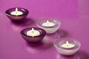 Image showing burning candles on purple background