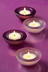 Image showing burning candles on purple background