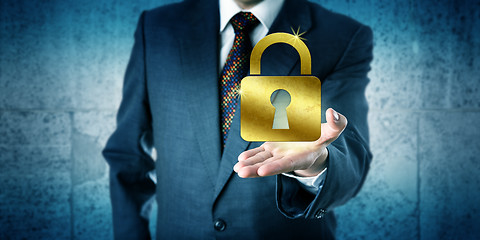 Image showing Business Man Showing A Golden Closed Padlock