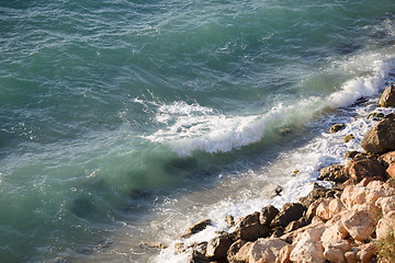 Image showing Rocky cliffs and turquoise sea water on sunny day