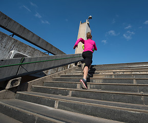 Image showing woman jogging on  steps