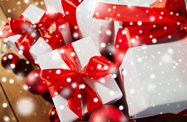 Image showing close up of gift boxes and red christmas balls