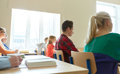 Image showing group of students with notebooks at school lesson