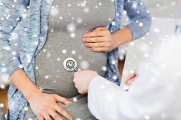 Image showing doctor with stethoscope and pregnant woman belly