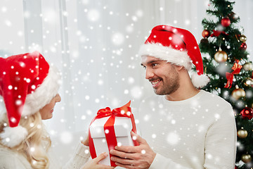 Image showing happy couple at home with christmas gift box