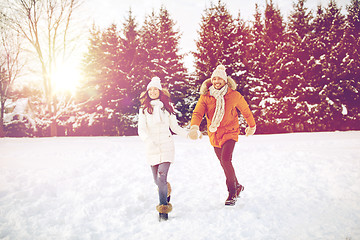 Image showing happy couple running in winter snow