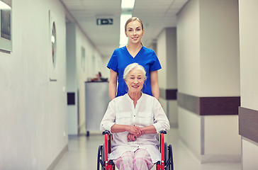 Image showing nurse with senior woman in wheelchair at hospital