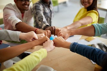 Image showing close up of international students hands fist bump