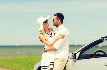 Image showing happy man and woman hugging near car at sea