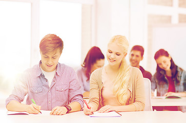 Image showing two teenagers with notebooks at school