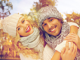 Image showing happy couple in warm clothes over autumn