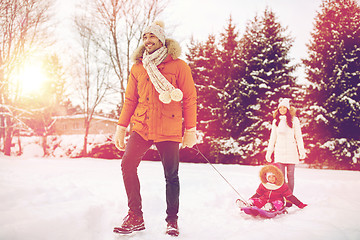 Image showing happy family with sled walking in winter outdoors