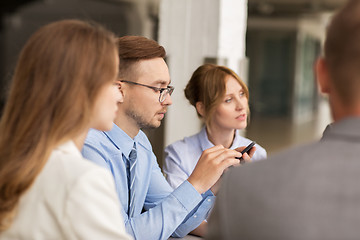 Image showing businessman texting on smartphone at office