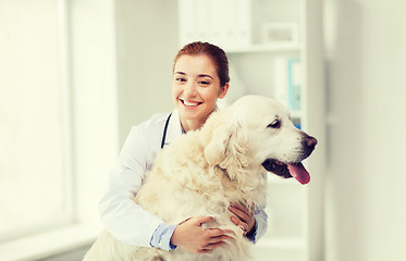 Image showing happy doctor with retriever dog at vet clinic