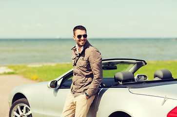 Image showing happy man near cabriolet car outdoors