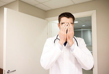 Image showing sad or crying male doctor at hospital ward