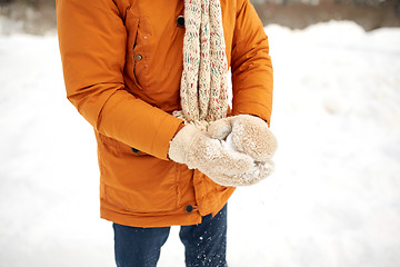 Image showing close up of man with snowball in winter