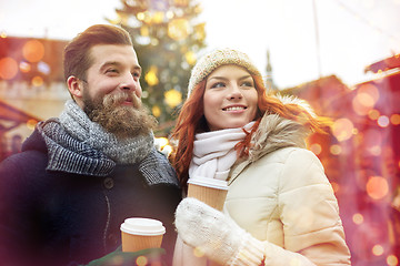 Image showing happy couple drinking coffee on old town street