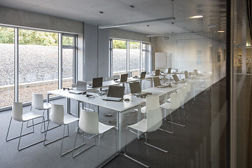 Image showing Empty white chairs in contemporary conference hall with