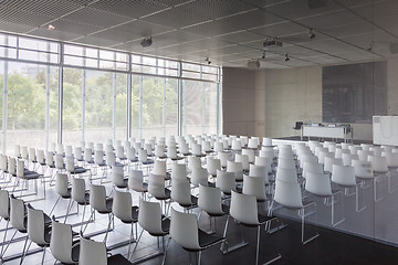 Image showing Empty white chairs in contemporary conference hall with