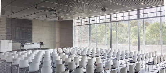Image showing Empty white chairs in contemporary conference hall with
