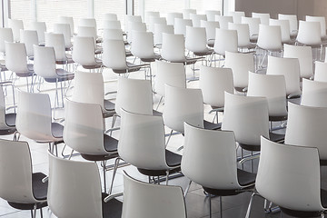 Image showing Empty white chairs in contemporary conference hall with