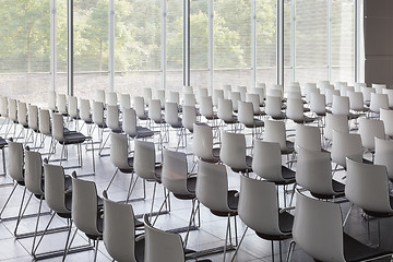 Image showing Empty white chairs in contemporary conference hall with