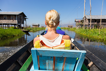 Image showing Female tourist travels by traditional boat.