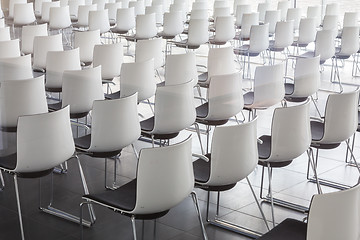 Image showing Empty white chairs in contemporary conference hall with