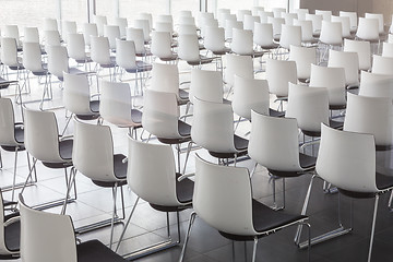 Image showing Empty white chairs in contemporary conference hall with